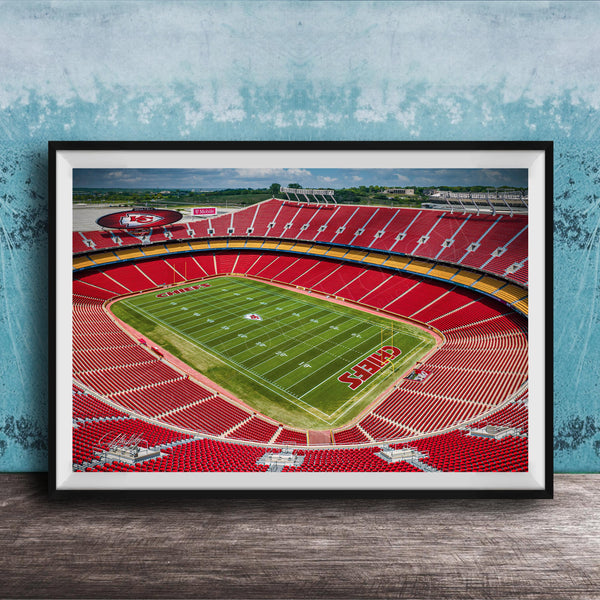 The image is a framed photograph of a football stadium, specifically Kansas City Chiefs Stadium, with a view of the field and seating areas.