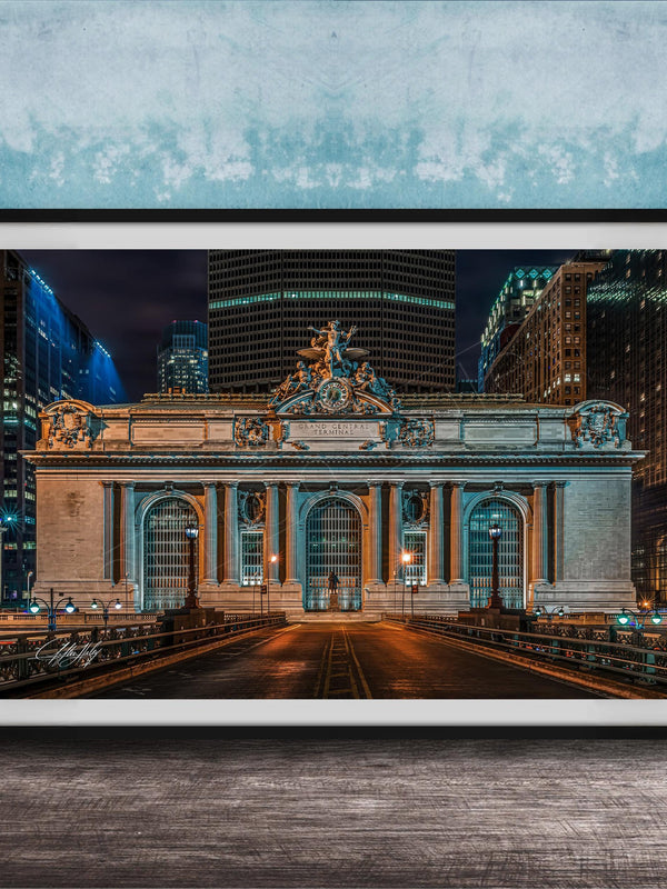 A framed photograph of the Grand Central Terminal in New York City at night, with the terminal's ornate facade and surrounding skyscrapers illuminated against a dark sky.