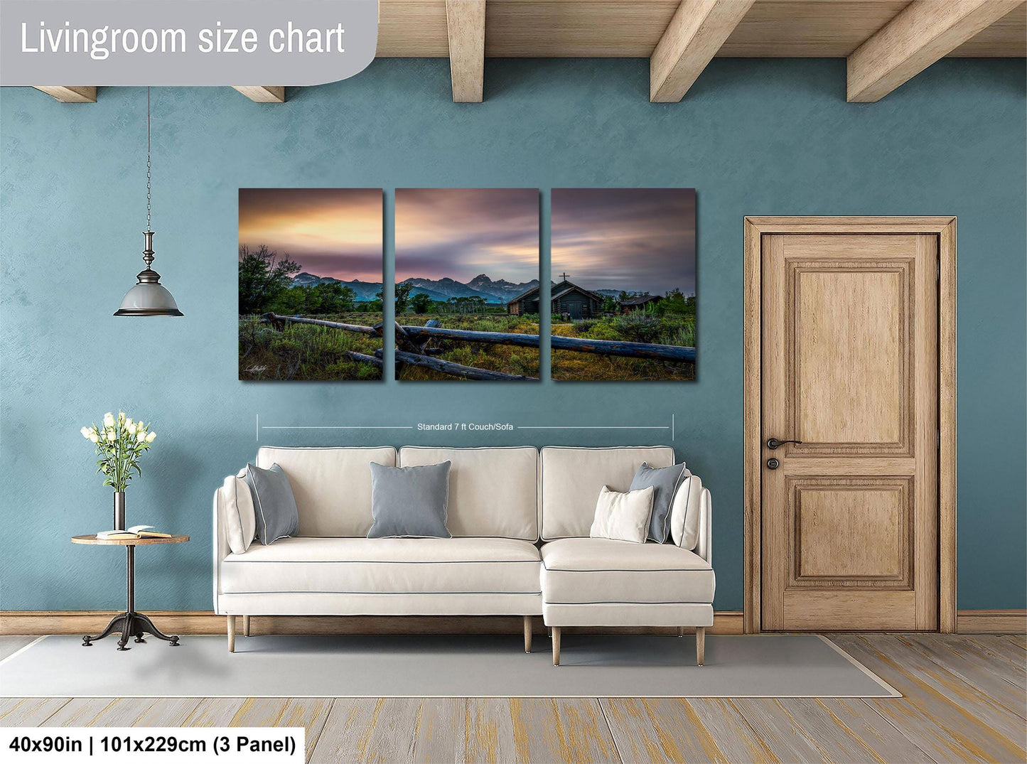 The image is a living room with a large, three-panel landscape painting hanging on the wall. The painting depicts a serene countryside scene with a house and trees in the distance. The room is furnished with a white sofa and a wooden door, creating a cozy and inviting atmosphere.