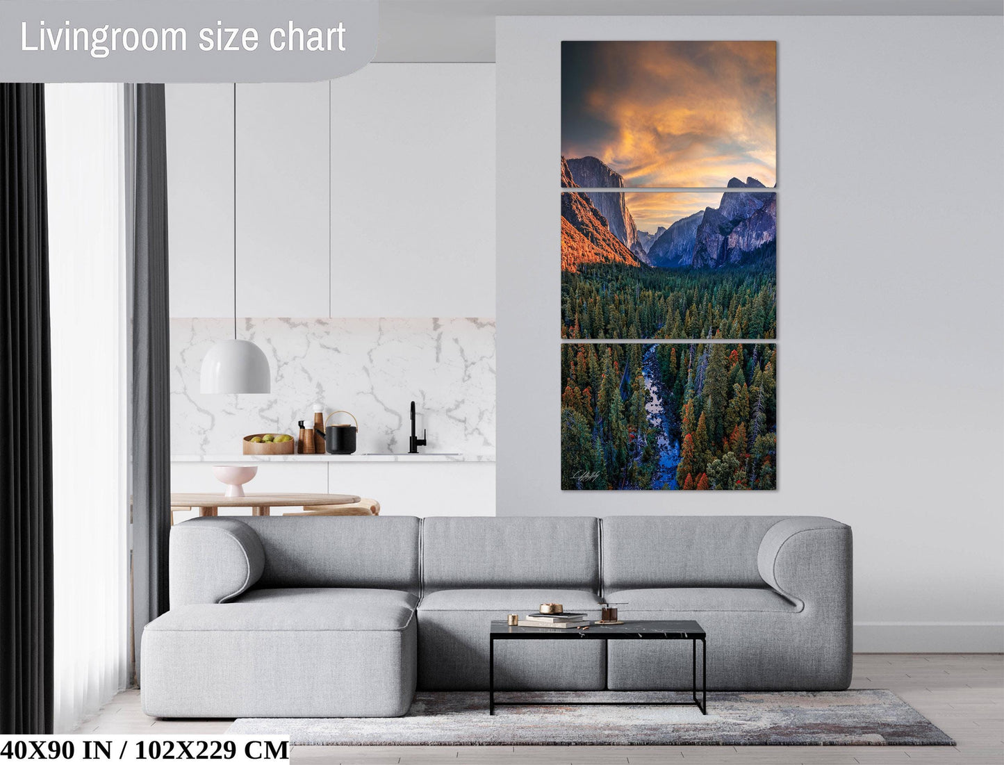 The image is a living room with a gray sofa, a coffee table, and a large wall art depicting a scenic mountain landscape with a river and trees.