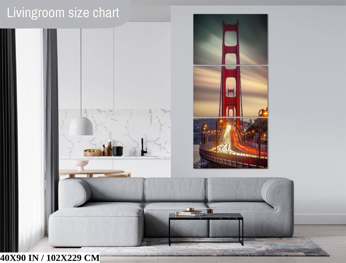 The image is a living room with a gray sofa and a coffee table. Above the sofa, there is a large painting of the Golden Gate Bridge, which is a famous landmark in San Francisco, California. The painting is divided into three panels, each depicting different parts of the bridge. The living room has a modern and minimalist design, with white walls and a gray carpet.