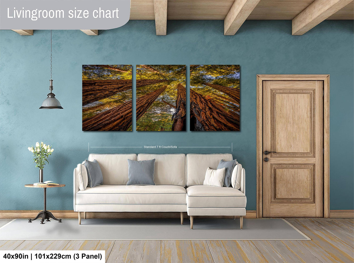 The image is a living room with a large white sofa, a wooden door, and a painting of a forest scene above it.