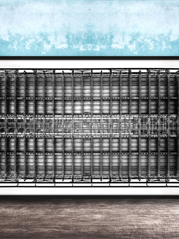 The image is a framed black and white photograph of a grid-like structure, possibly a building or a machine, set against a blue textured wall.
