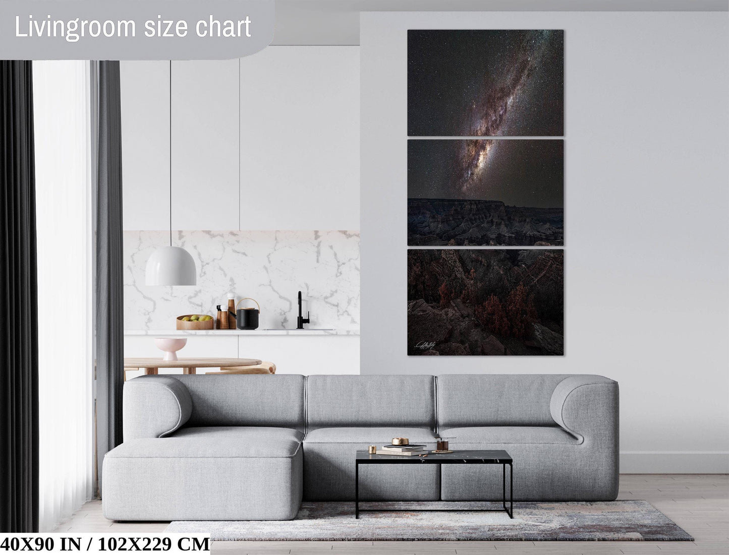 The image is a living room with a gray sofa, a coffee table, and a large wall art depicting a galaxy. The wall art is a collage of three images, and the living room has a modern and minimalist design.