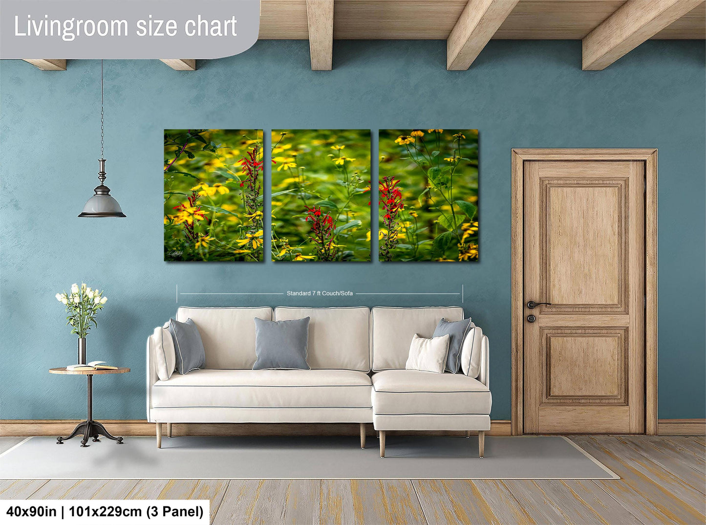 The image is a living room with a white sofa, a wooden door, and a hanging light fixture. Above the sofa, there is a large living room size chart that provides dimensions for the artwork displayed on the wall.