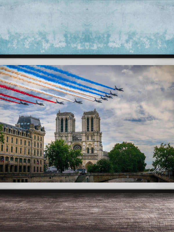 A framed photograph of the French Air Force performing a military air show, with fighter jets flying in formation and leaving trails of smoke in the sky. The backdrop is the iconic Notre-Dame Cathedral in Paris.