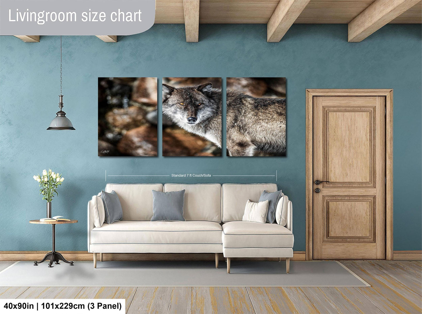 The image is a living room with a white sofa, a wooden door, and a hanging light fixture. There is a large painting of a wolf on the wall above the sofa.