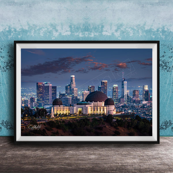 A framed photograph of the Los Angeles skyline at night, with the Griffith Observatory prominently featured in the foreground.