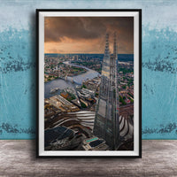 The image is a framed aerial view of the London skyline, showcasing the iconic Shard skyscraper and the River Thames in the background.