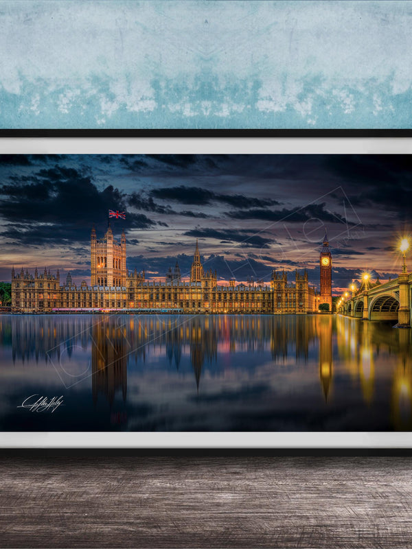 a city skyline at night, with the buildings illuminated and reflected in the water below.