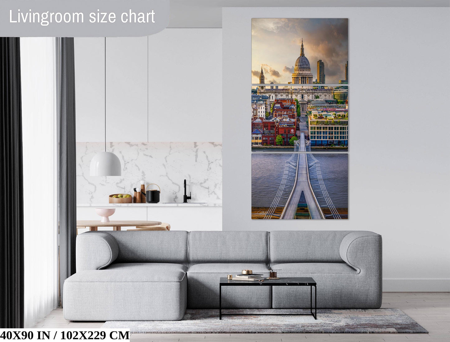The image is a living room with a gray sofa and a coffee table in front of it. Above the sofa, there is a large wall art depicting a cityscape with a bridge and a dome. The wall art is framed and hangs on the wall.