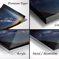 The image is a collage of four different views of a night sky, each with a different finish or material. The top left image is a "Premium Paper" print, the top right image is a "Canvas Wrap", the bottom left image is an "Acrylic" print, and the bottom right image is a "Metal/Aluminum" print.