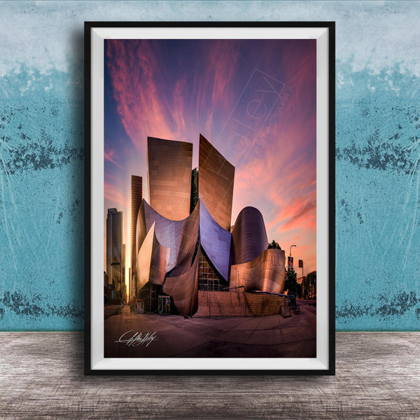A framed photograph of the Guggenheim Museum in Los Angeles, California, with its distinctive curved architecture and vibrant sunset sky in the background.