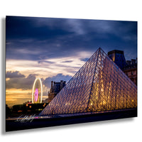 a large glass pyramid structure with a ferris wheel in the background, set against a colorful sunset sky.