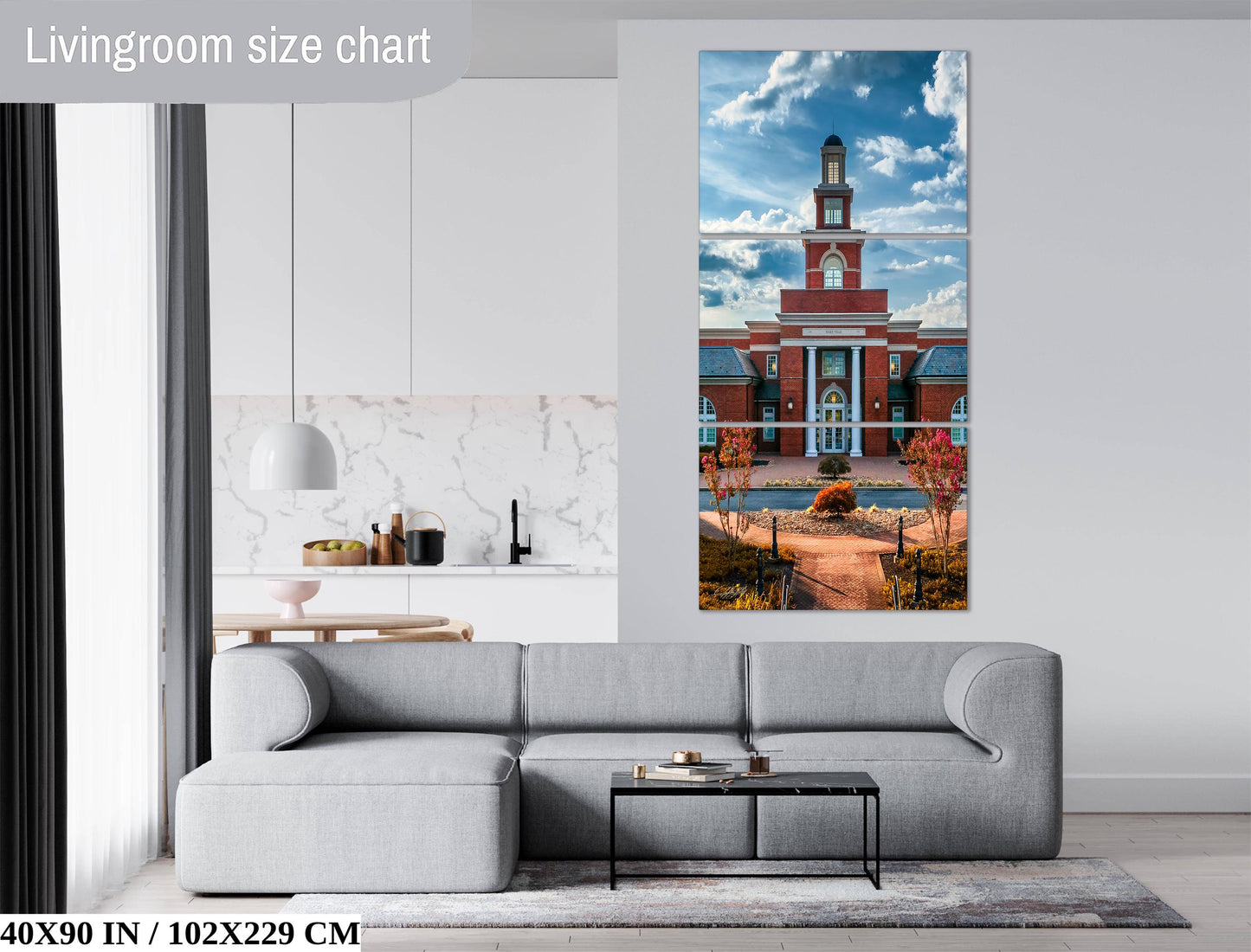 The image is a living room with a gray sofa, a coffee table, and a large painting of a building with a clock tower on the wall.