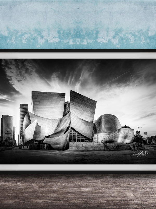 A black and white photograph of the Walt Disney Concert Hall in Los Angeles, California, with its distinctive curved roof and modern architectural design.