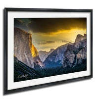 a breathtaking view of a mountainous landscape at sunset, with towering cliffs and a waterfall cascading down the side.
