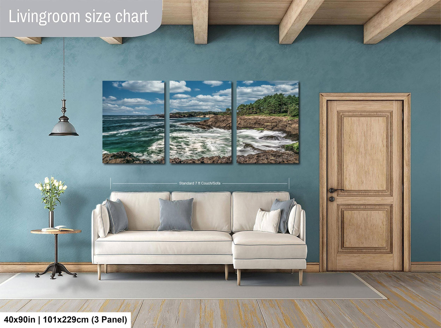 The image is a living room with a large white sofa, a wooden door, and a painting of a coastal landscape above it.