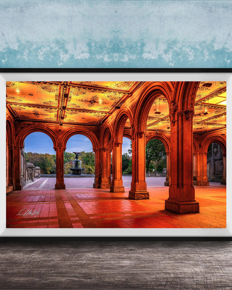 A framed photograph of a grand, ornate building with arched doorways and columns, illuminated by warm lighting, creating a visually striking and inviting scene.