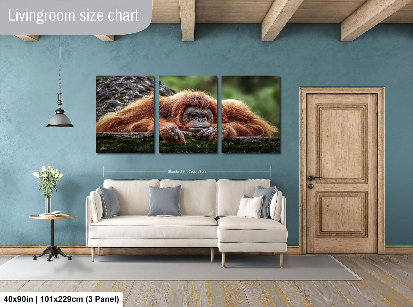 The image is a living room with a large, high-quality photograph of an orangutan displayed on the wall. The photograph is composed of three panels, and the living room has a white sofa and a wooden door.