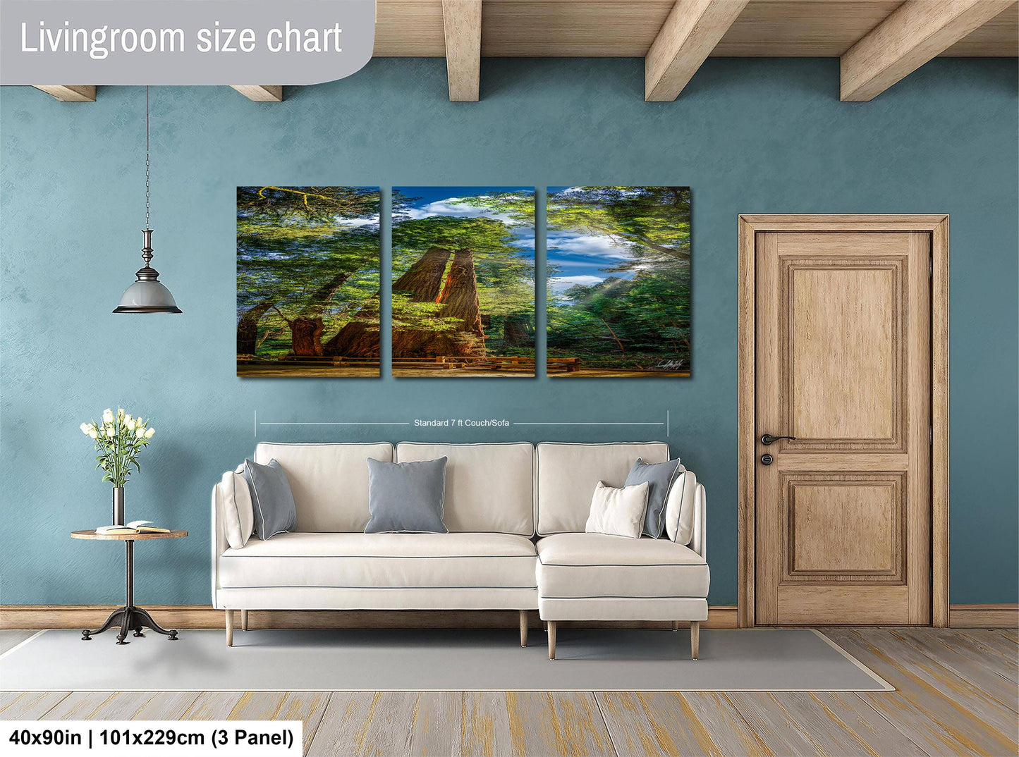 The image is a living room with a large, three-panel landscape painting hanging on the wall. The painting depicts a serene scene of trees and a body of water. The room is furnished with a white sofa and a wooden door, creating a cozy and inviting atmosphere.