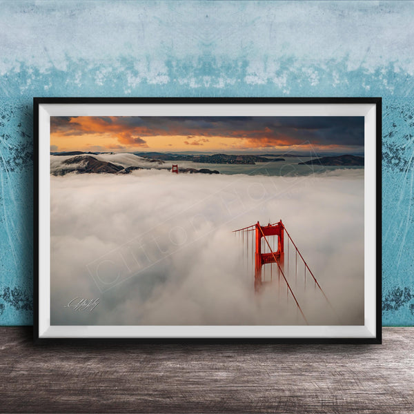 A framed photograph depicting the Golden Gate Bridge in foggy conditions, with the bridge's iconic red towers visible through the mist.