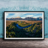 The image is a framed aerial view of a mountainous landscape with a winding river, surrounded by lush forests.