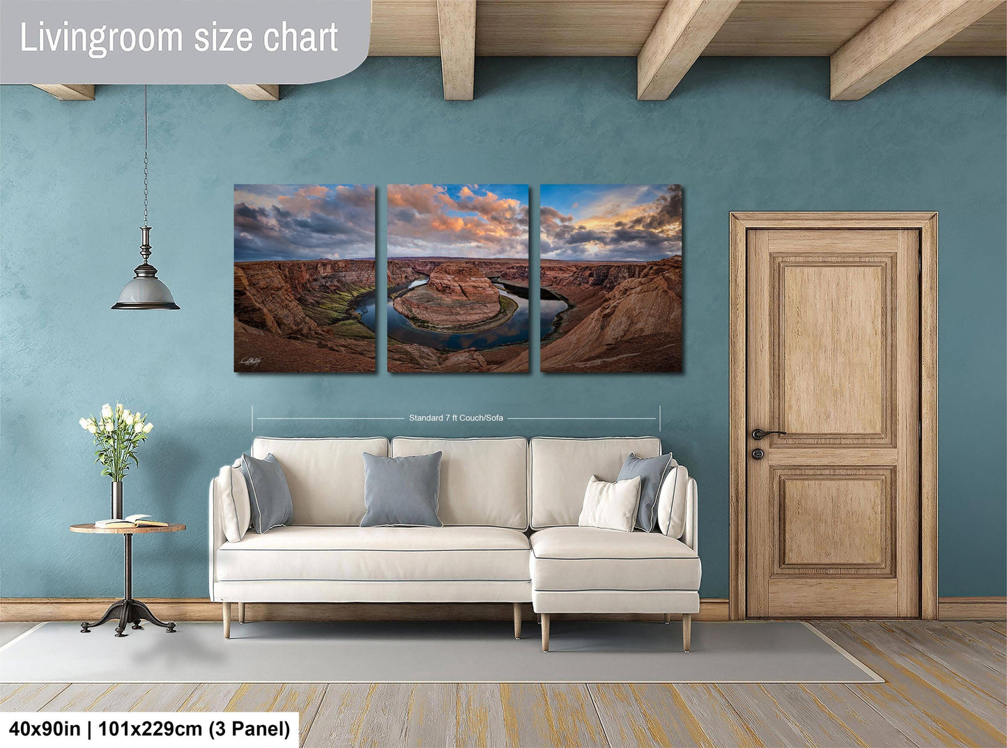 The image is a livingroom with a large living room size chart on the wall, featuring a three-panel landscape painting depicting a scenic desert landscape with a winding river.