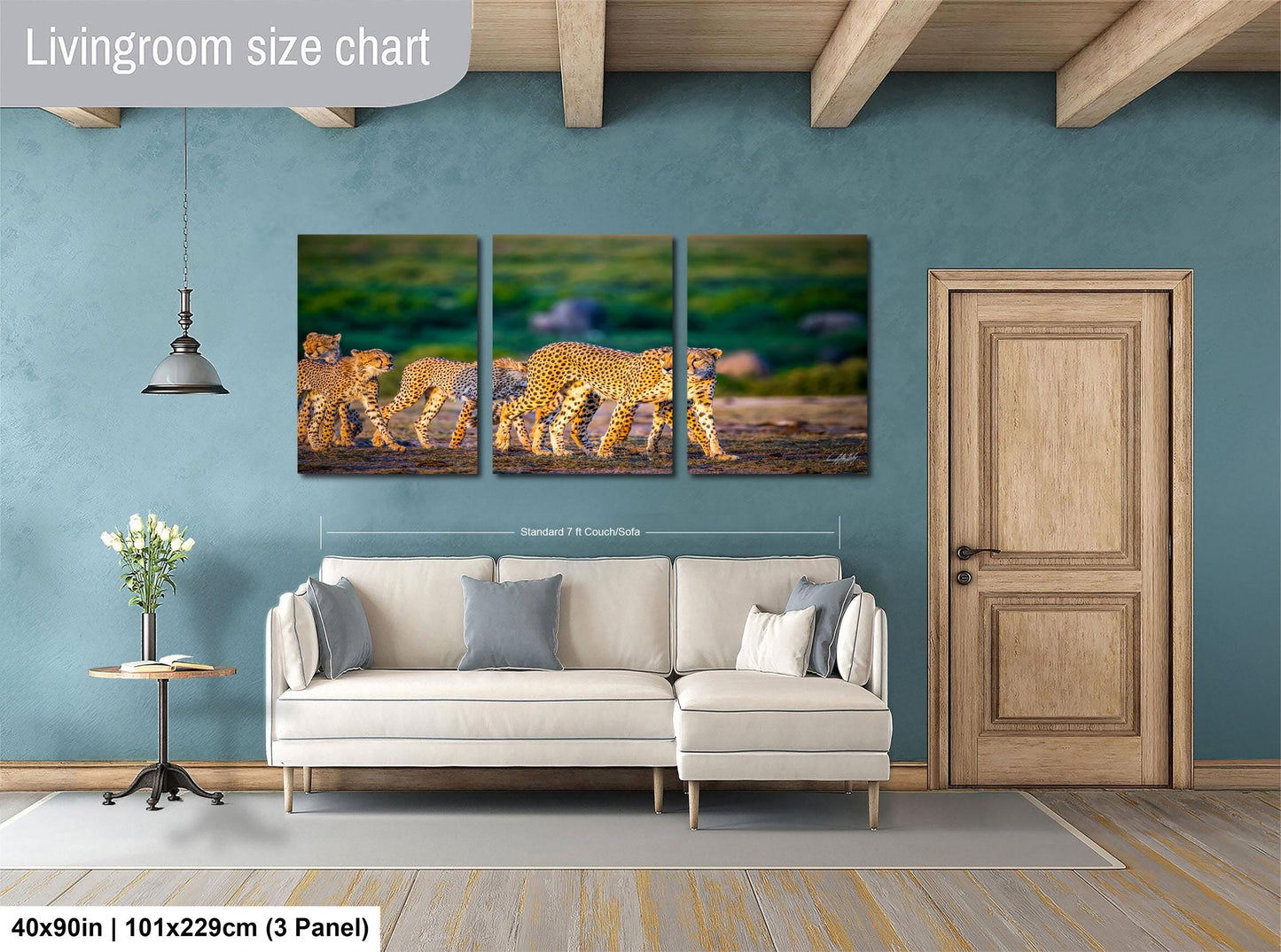 The image is a livingroom size chart that includes a large painting of a group of leopards walking across a grassy field, a white sofa, a wooden door, and a small table with a vase of flowers.