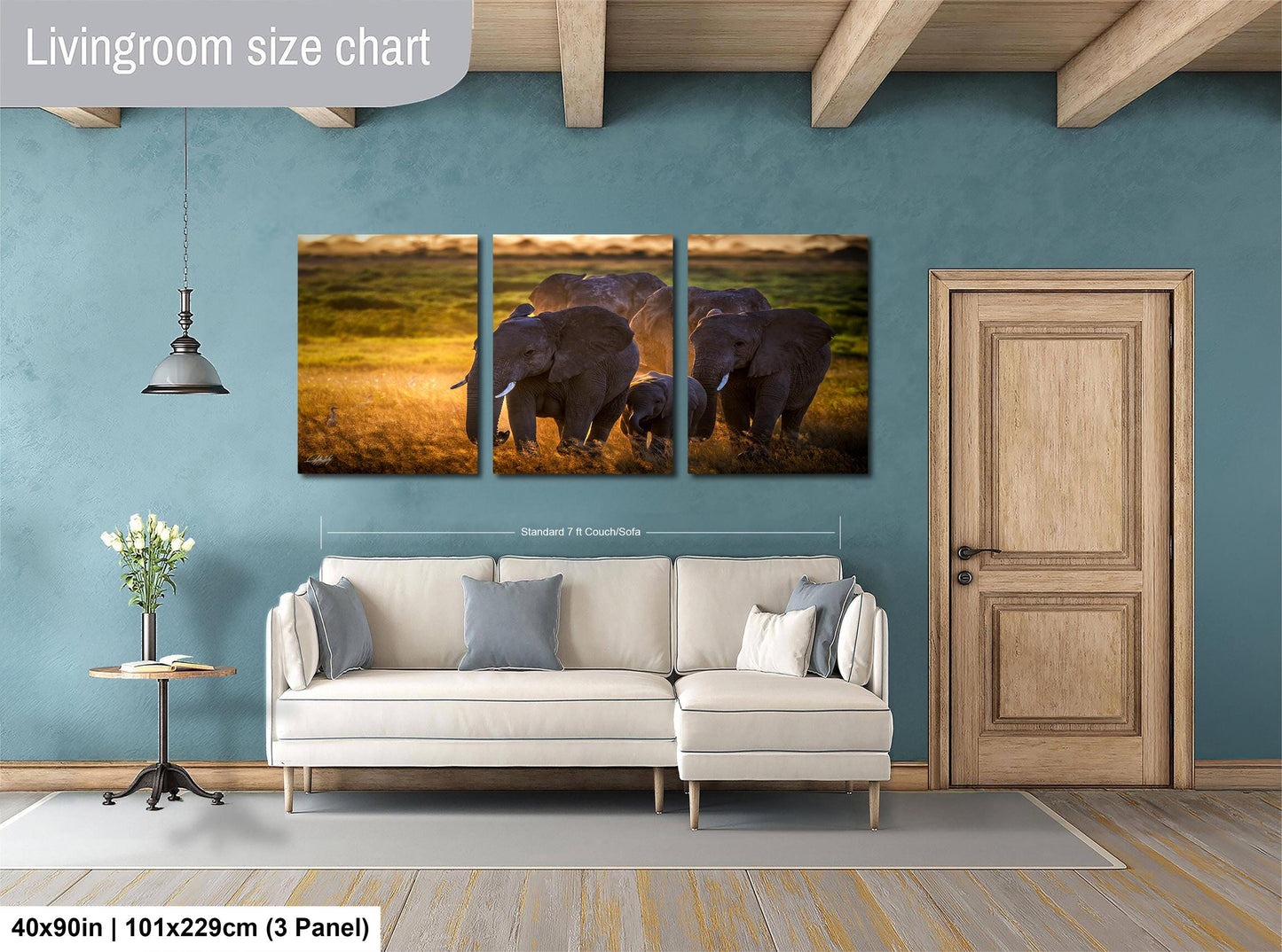 The image is a livingroom size chart that includes a large painting of elephants in a field, a white sofa, a wooden door, and a small table with a vase of flowers.