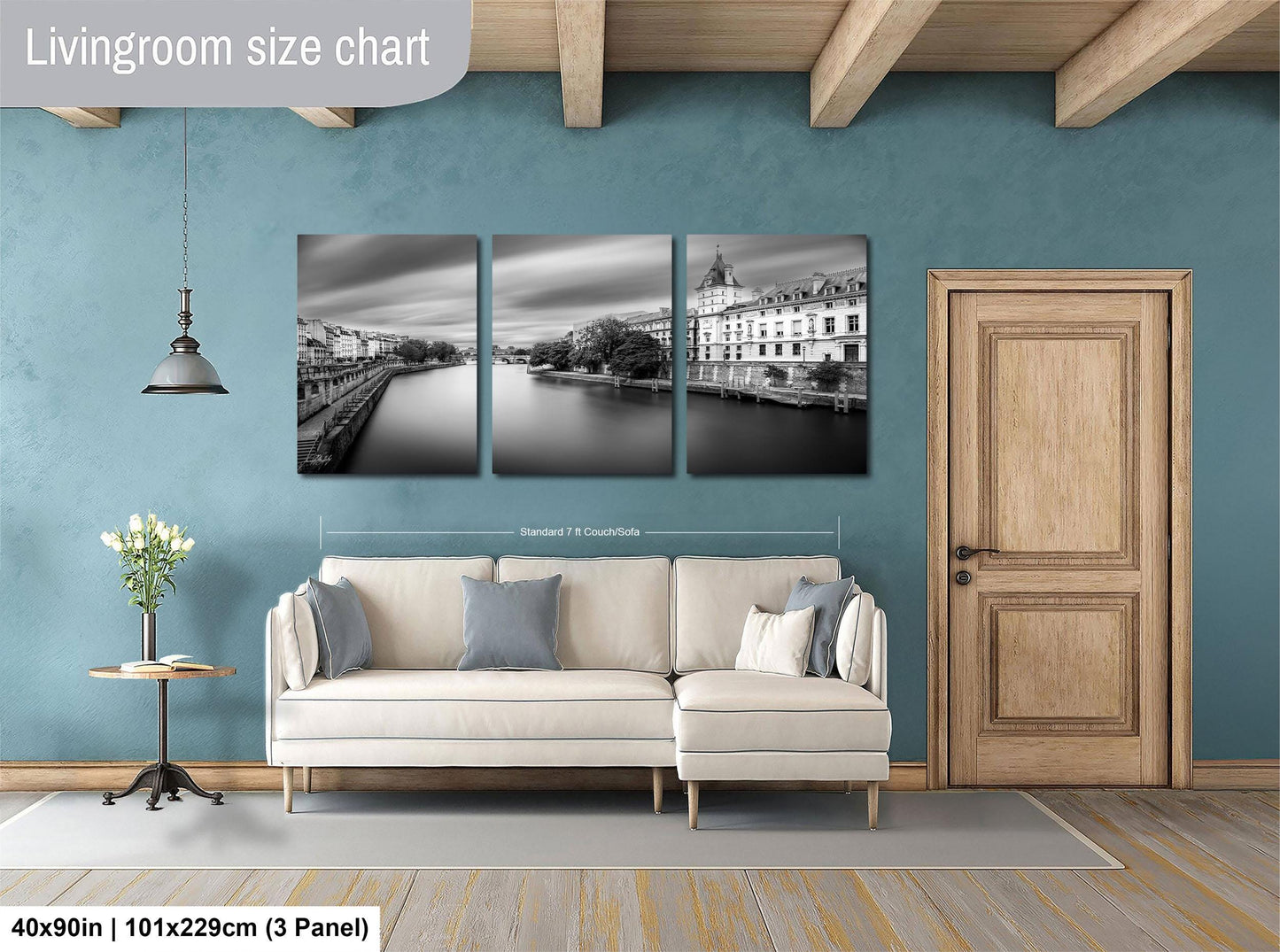 The image is a living room with a white sofa and a wooden door. Above the sofa, there is a living room size chart that provides dimensions for the artwork displayed on the wall.