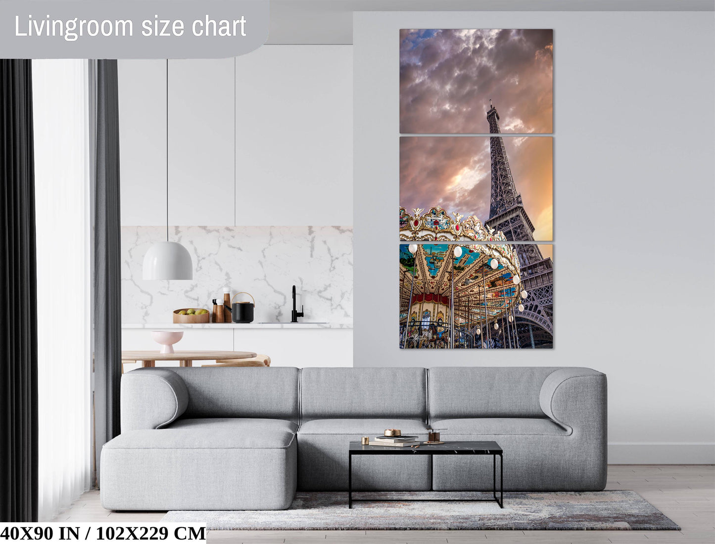 The image is a living room with a gray sofa and a coffee table in front of it. Above the sofa, there is a large painting of the Eiffel Tower and a carousel. The painting is a triptych, which means it consists of three panels. The living room has a modern and minimalist design, with white walls and a gray color scheme.