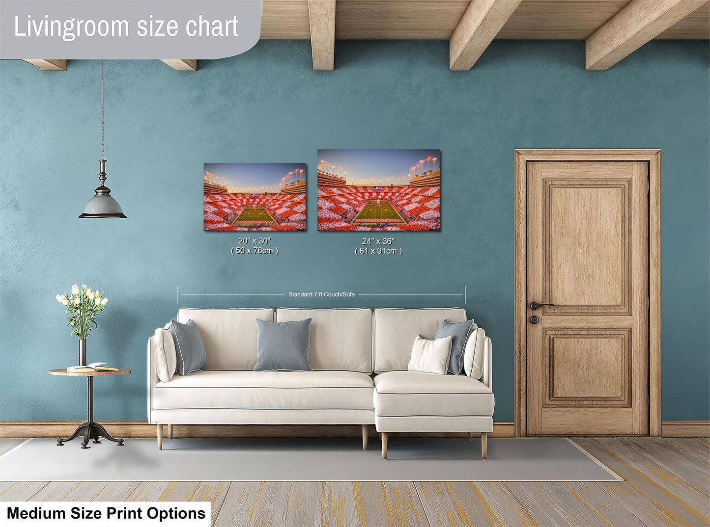 a living room with a white sofa, a wooden door, and a painting of a stadium on the wall. The painting is of a stadium with a field and a scoreboard. The sofa is positioned in front of the painting, and the door is located to the right of the sofa. The image is described as a medium-sized print, and it includes the text "Livingroom size chart" and "MEDIUM SIZE PRINT OPTIONS".