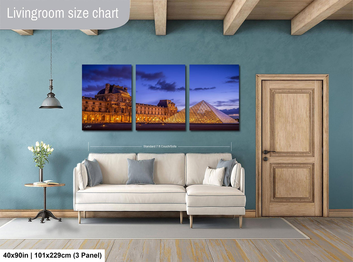The image is a living room with a large wall art collage depicting the Louvre Museum in Paris, France. The collage consists of three separate images showing different parts of the museum, including the Arc de Triomphe and the Louvre Museum itself. The collage is framed by a wooden door and a white sofa, creating a cozy and inviting atmosphere in the room.