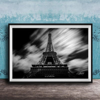 A framed black and white photograph of the Eiffel Tower, a famous landmark in Paris, France.