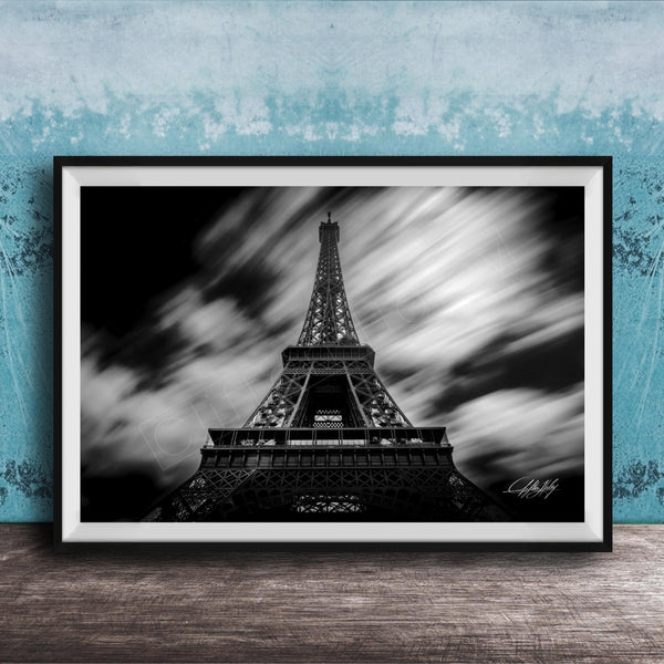 A framed black and white photograph of the Eiffel Tower, a famous landmark in Paris, France.