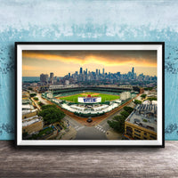 The image is a framed photograph of a baseball stadium in Chicago, Illinois, with the city skyline in the background.