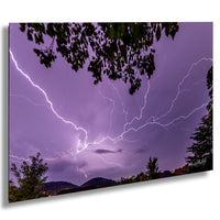 a dramatic lightning storm with bolts of bright light streaking across the dark purple sky, creating a stunning and awe-inspiring scene.