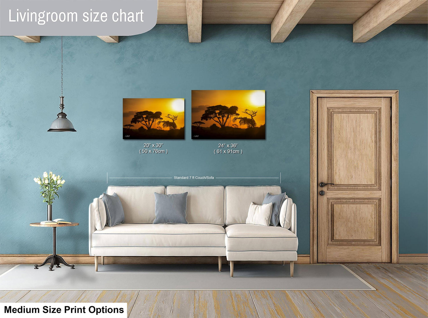 a living room with a white sofa, a wooden door, and a painting of a sunset on the wall. The painting is of a landscape with trees and a sky. The living room appears to be well-decorated and spacious.