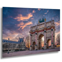 a large, ornate archway with intricate carvings and statues, set against a vibrant sky with colorful clouds. The archway is surrounded by trees and other buildings, creating a picturesque scene.
