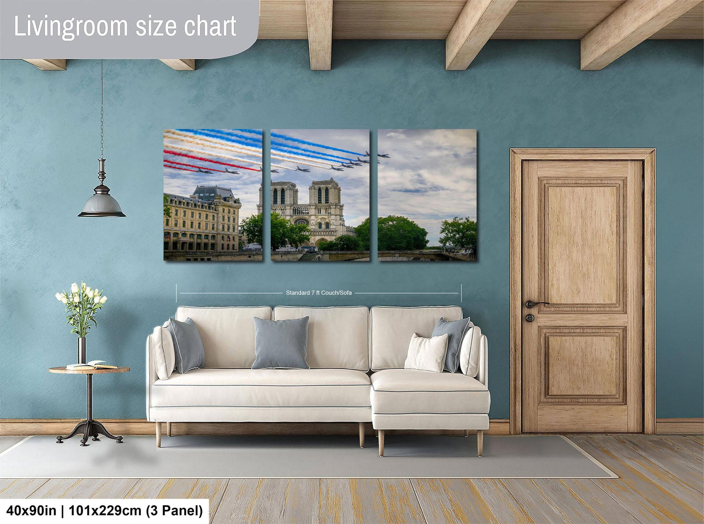 The image is a living room with a white sofa and a wooden door. Above the sofa, there is a large living room size chart that provides dimensions for the artwork. The artwork is a collage of three images depicting a city skyline and a red, white, and blue airplane in flight.
