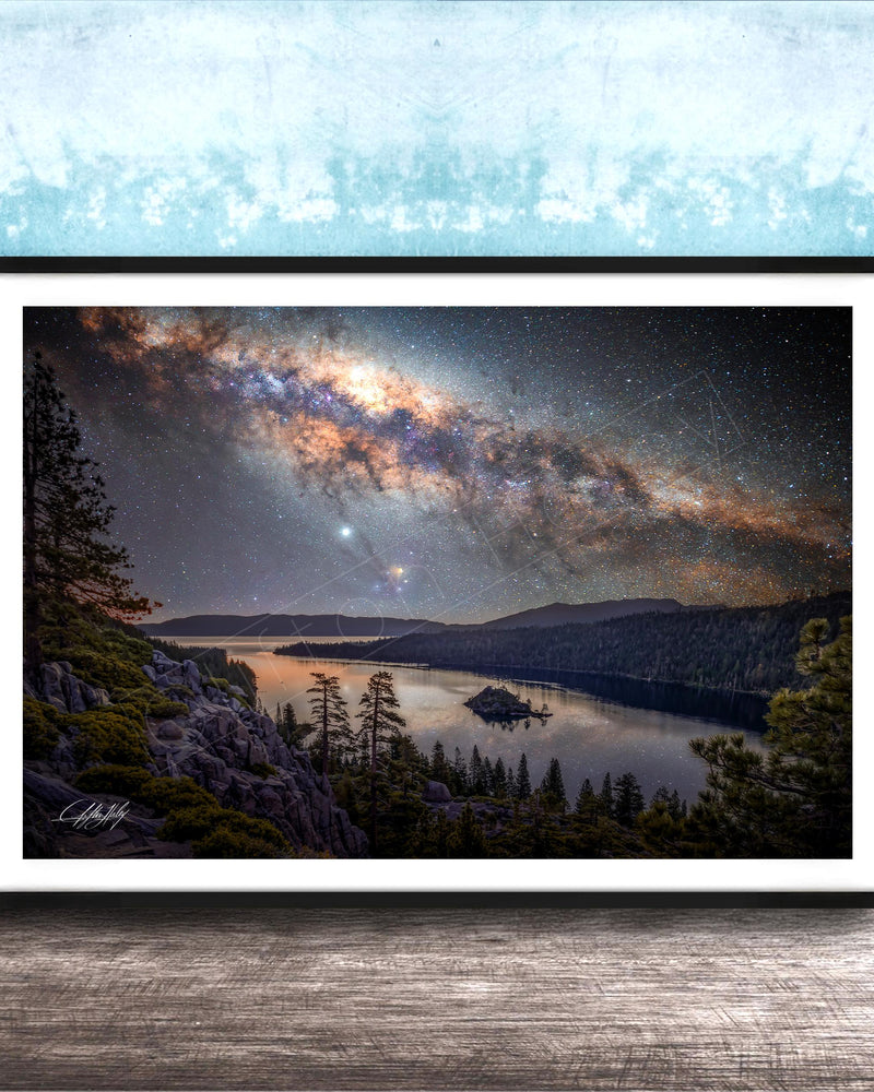 The image is a framed photograph depicting a serene night scene with a lake, mountains, and a starry sky.