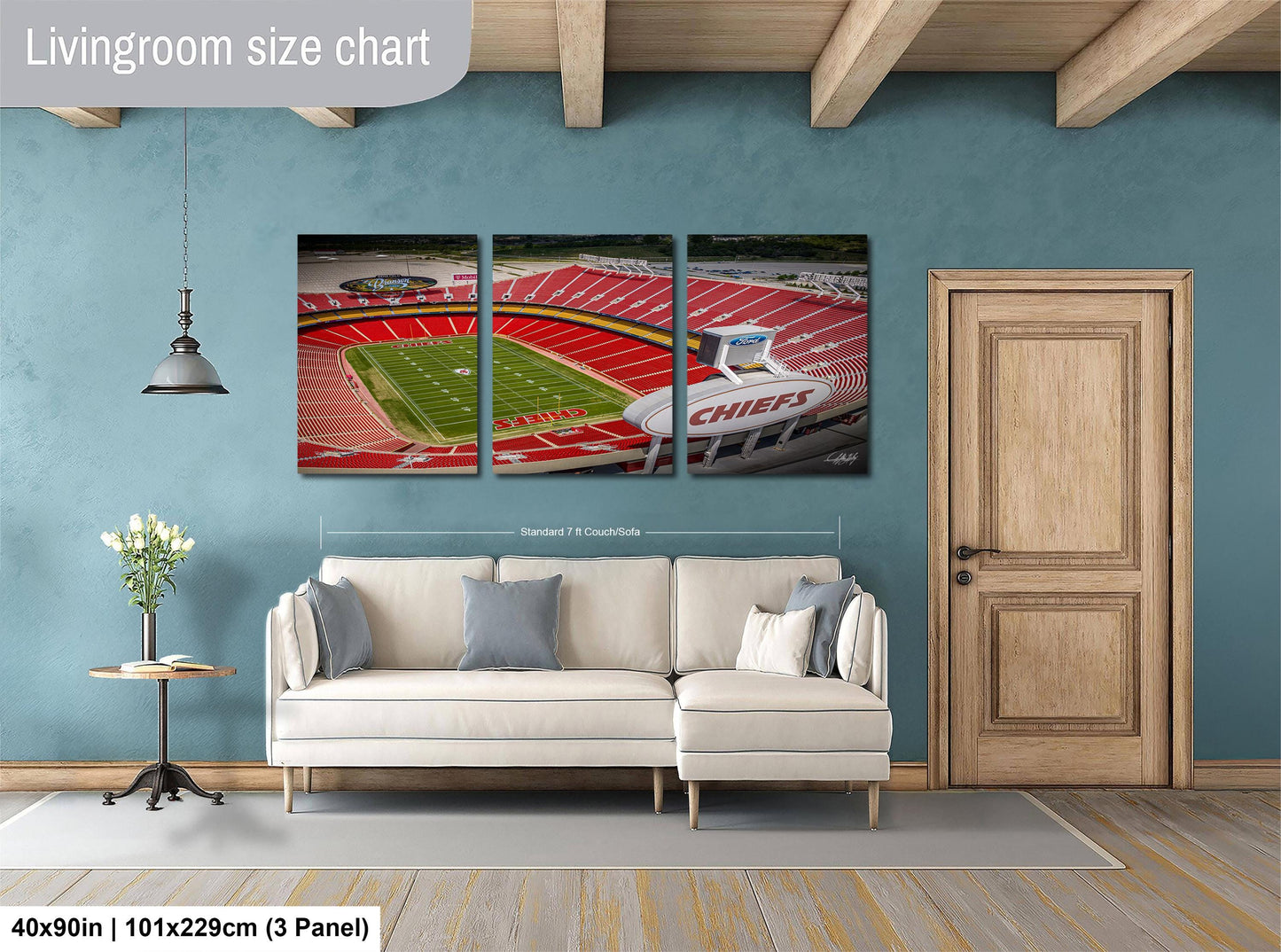 The image is a living room with a large wall art depicting a football stadium. The wall art is divided into three panels, each showing different parts of the stadium. The living room has a white sofa and a wooden door.
