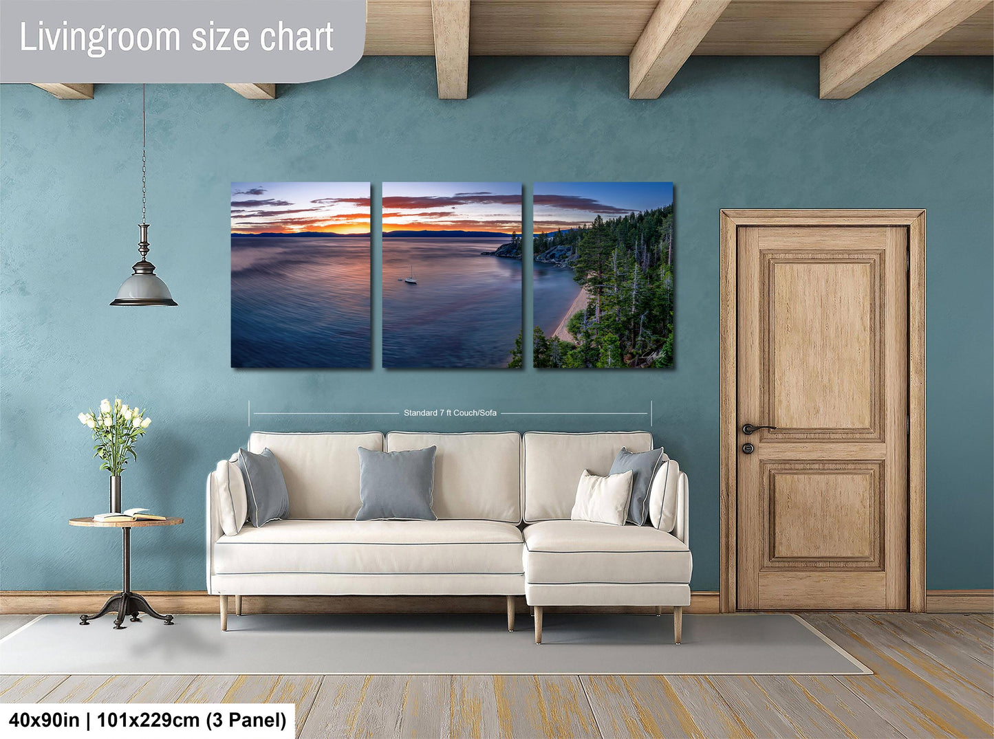 The image is a living room with a large wall art depicting a serene landscape of a lake at sunset. The wall art is divided into three panels, each showcasing different aspects of the scene. The living room has a white sofa and a wooden door, creating a cozy and inviting atmosphere.