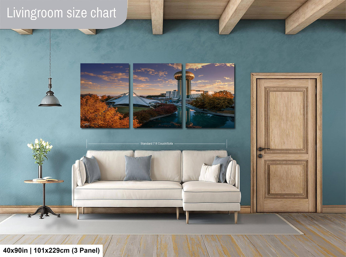 The image is a living room with a white sofa and a wooden door. Above the sofa, there is a large living room size chart that provides dimensions for the artwork displayed on the wall.