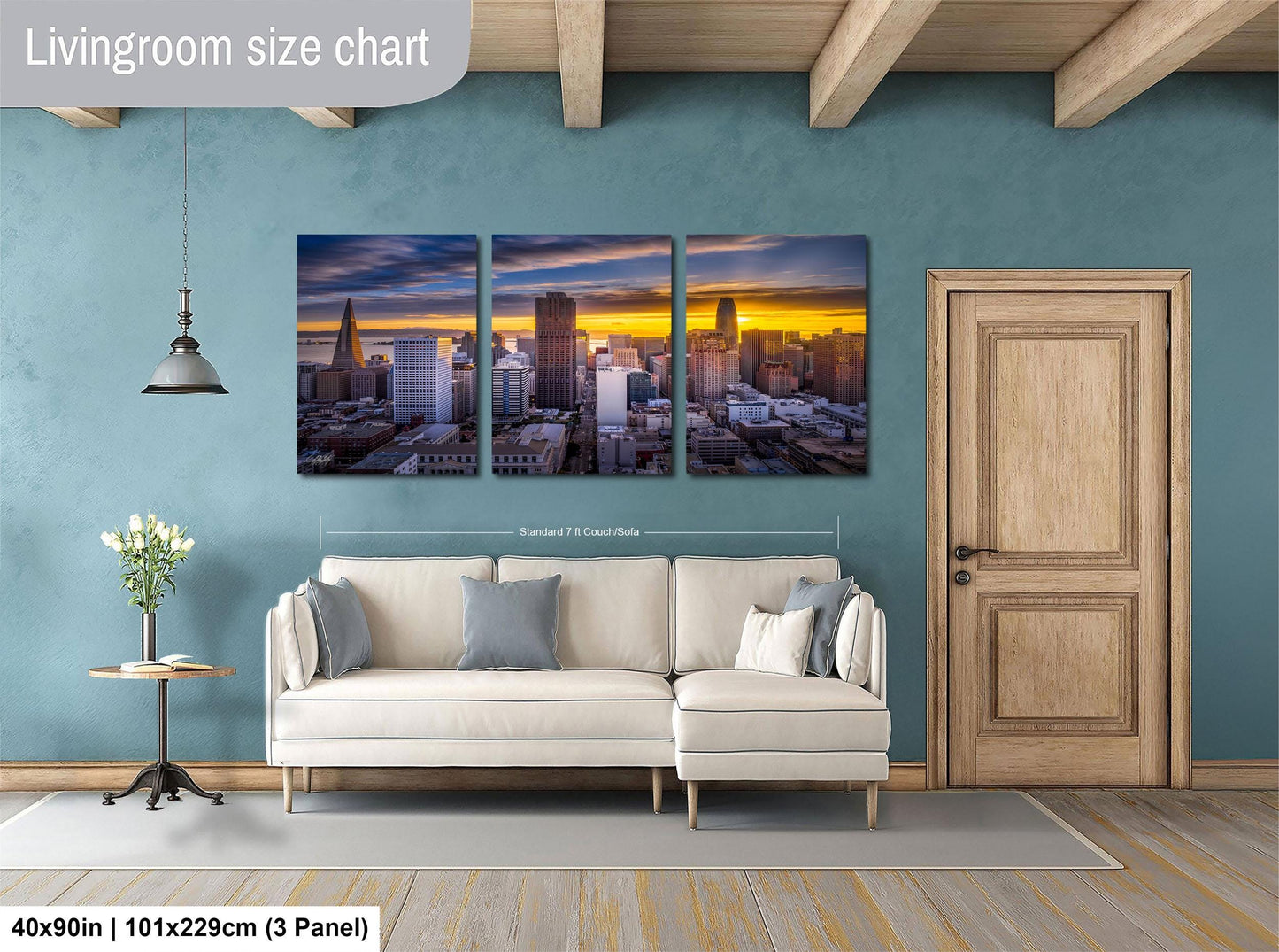 The image is a living room with a large, three-panel living room size chart on the wall. The chart displays the dimensions of the living room in feet and inches, with the largest panel being 40'x50'', the medium panel being 101'x129'', and the smallest panel being 103'x229''. The living room also includes a white sofa, a wooden door, and a small table with a vase of flowers.