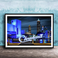 A framed photograph of the Cleveland skyline at night, with the city's iconic landmarks illuminated against a dark sky.