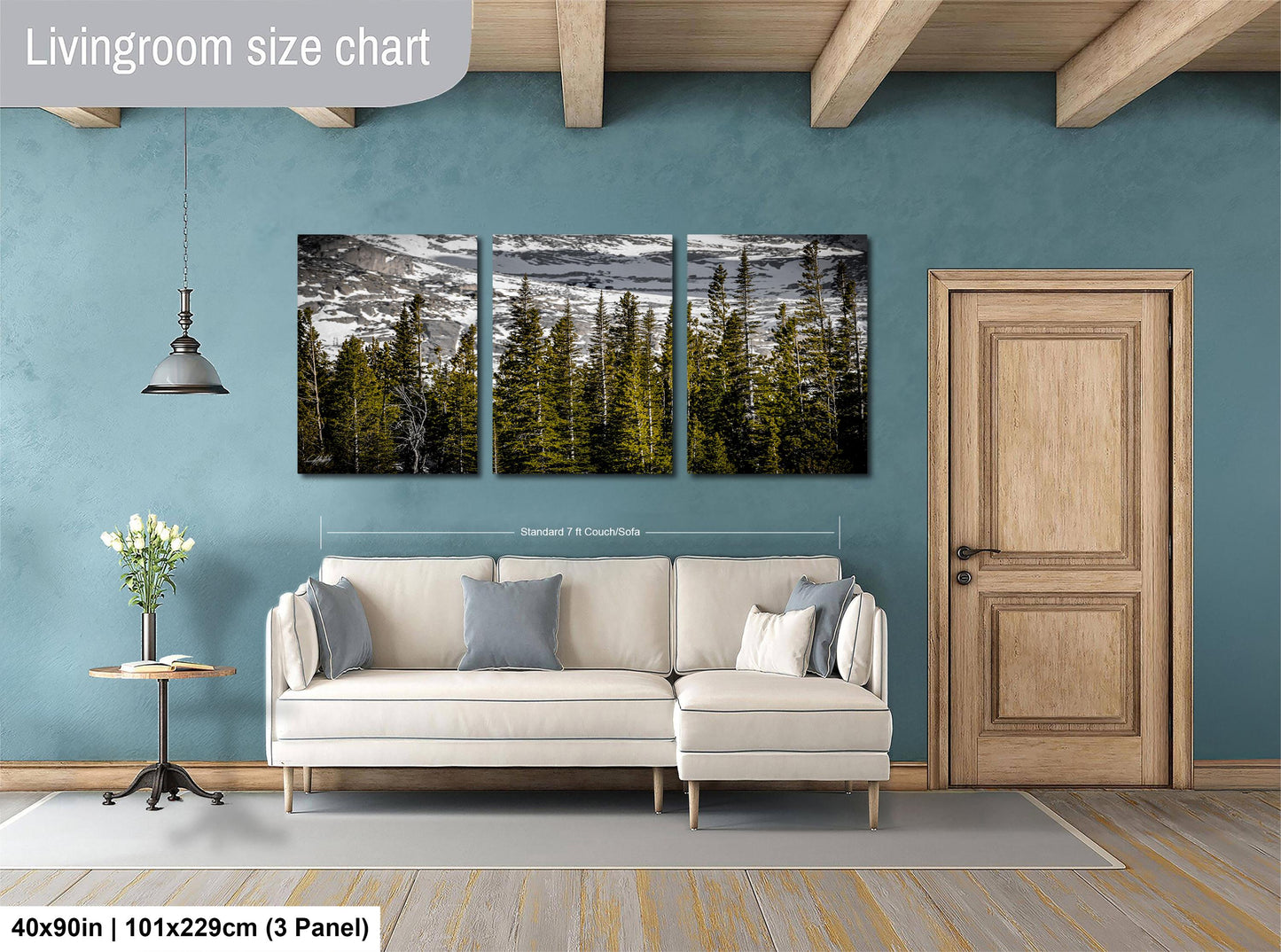 The image is a living room with a large painting of a forest scene hanging on the wall. The painting is divided into three panels, and the room has a white sofa, a wooden door, and a small table with a vase of flowers.