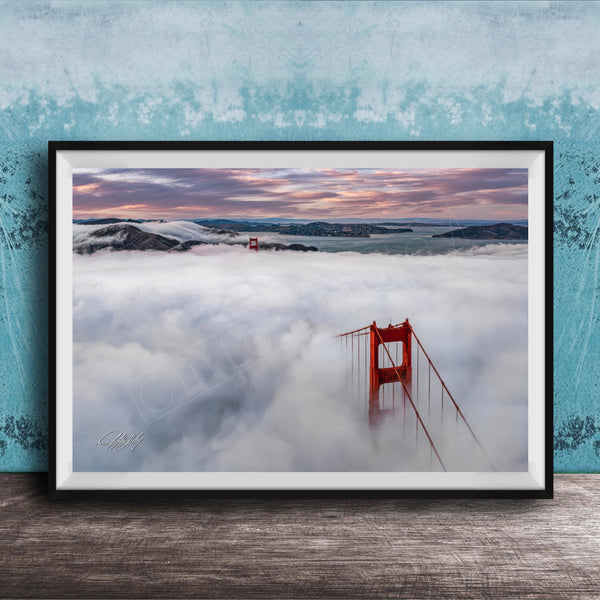 A framed photograph depicting the Golden Gate Bridge in foggy conditions, with the bridge's iconic red towers visible through the mist.