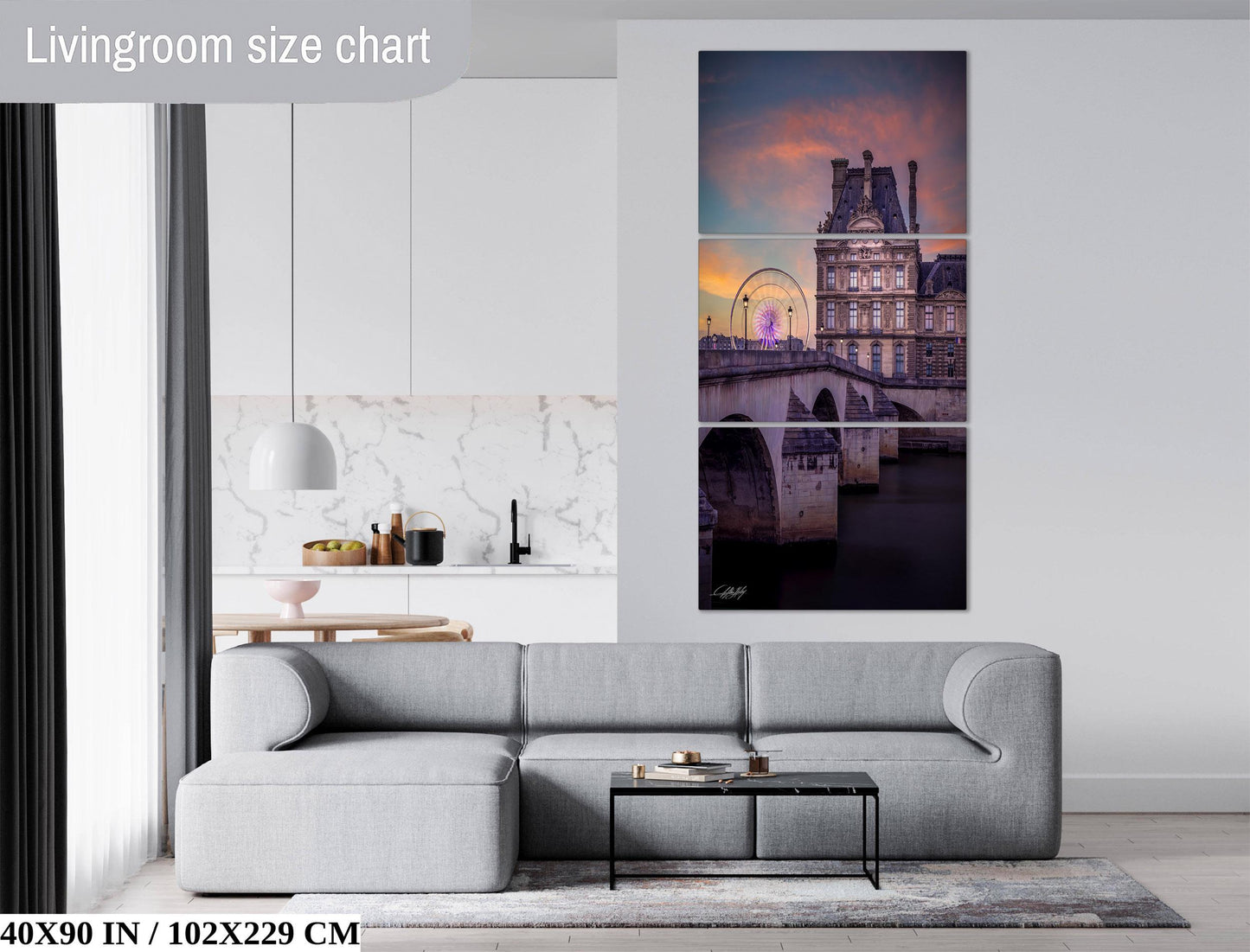 The image is a living room with a gray sofa, a coffee table, and a large wall art depicting a cityscape with a bridge and a ferris wheel.